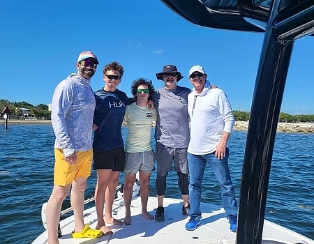 Group of five men standing on a boat in Key Largo ready for offshore fishing.