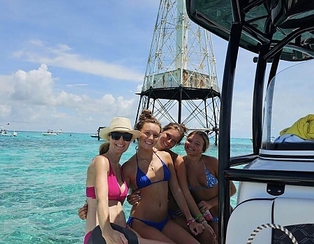Group of women on a boat near a lighthouse in Islamorada.