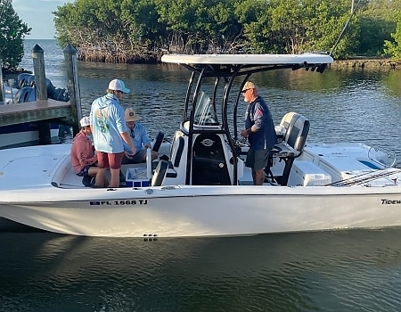 Four people on a boat preparing for a fishing trip in Islamorada.