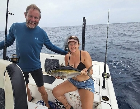 Man and woman holding a fish on a boat in Key Largo.